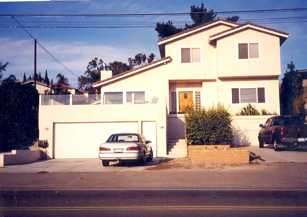 Modern two-story suburban house with garage and driveway, parked car in front